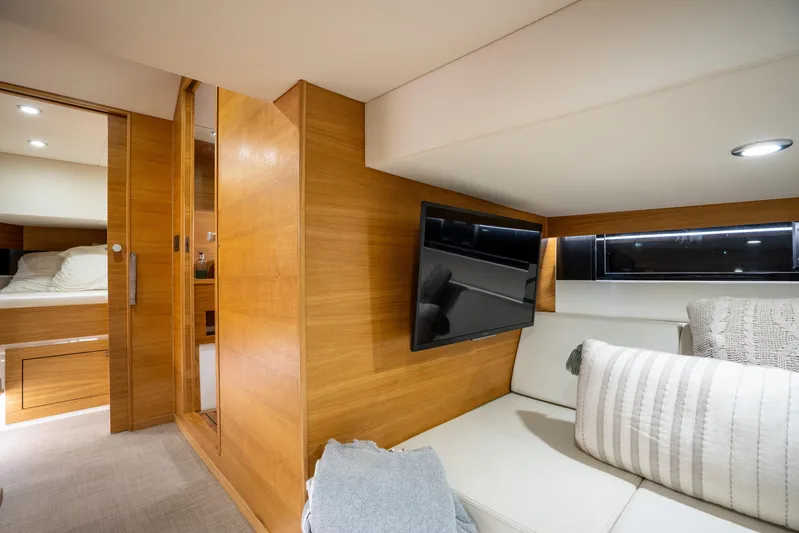  Yacht Photos Pics Luxurious interior of 2023 De Antonio Yachts D42 Open with modern wood finish and cozy seating.