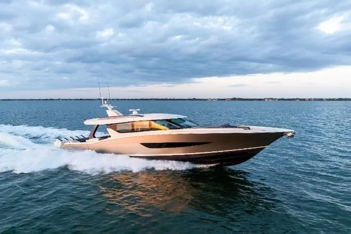  Yacht Photos Pics 2026 Scout 670 LXS luxury yacht cruising on open water under a cloudy sky.