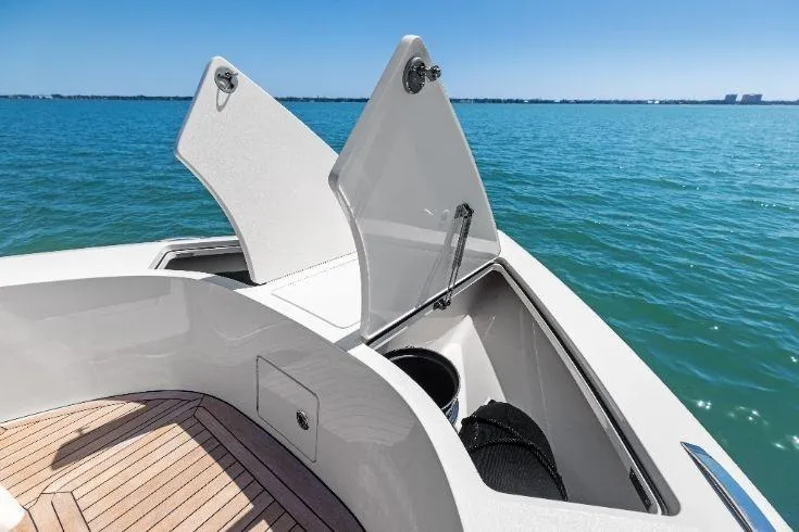  Yacht Photos Pics 2026 Scout 670 LXS boat with open storage compartments on a sunny day at sea.