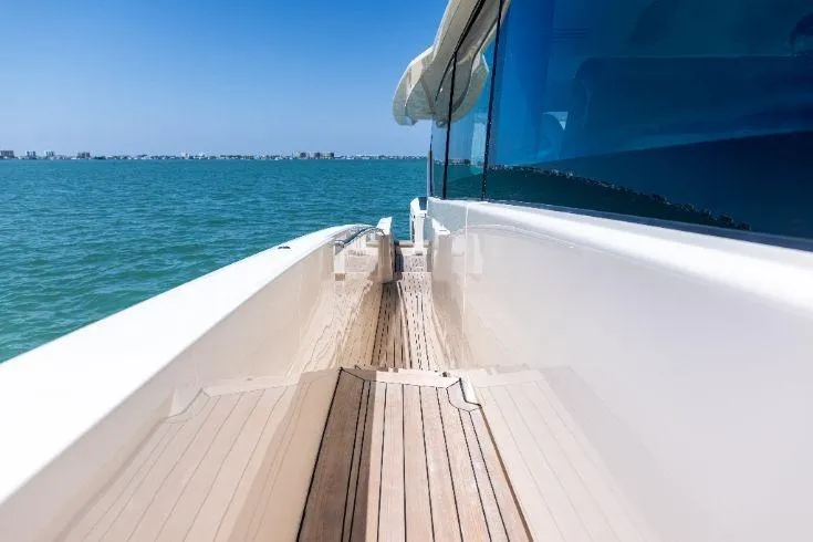 Yacht Photos Pics 2026 Scout 670 LXS yacht deck with ocean view and clear blue sky.