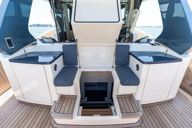  Yacht Photos Pics 2026 Scout 670 LXS boat interior with seating and storage, featuring sleek design and wood accents.
