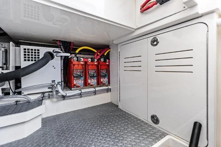  Yacht Photos Pics 2026 Scout 670 LXS boat battery compartment with red batteries and wiring.