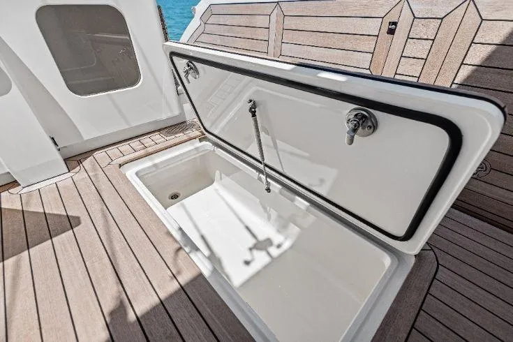  Yacht Photos Pics 2026 Scout 670 LXS boat storage compartment with open lid on teak deck.
