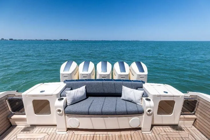  Yacht Photos Pics Luxury 2026 Scout 670 LXS boat with plush seating and multiple engines on open water.