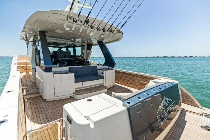  Yacht Photos Pics 2026 Scout 670 LXS luxury boat with spacious deck and fishing rods on a sunny day.