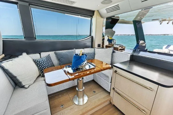  Yacht Photos Pics Luxurious interior of 2026 Scout 670 LXS yacht with ocean view and elegant seating area.