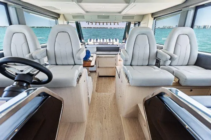  Yacht Photos Pics Luxurious interior of 2026 Scout 670 LXS boat with plush seating and ocean view.