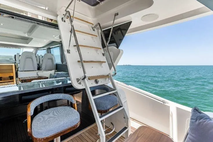  Yacht Photos Pics Luxury interior of 2026 Scout 670 LXS yacht with ocean view and seating area.