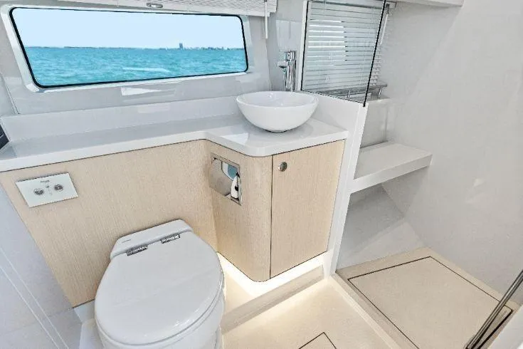  Yacht Photos Pics Luxurious bathroom interior of 2026 Scout 670 LXS yacht with ocean view.