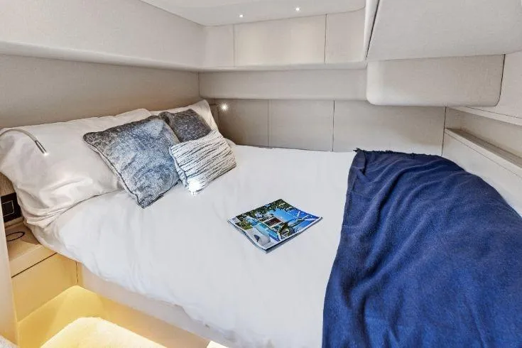  Yacht Photos Pics Luxurious cabin interior of 2026 Scout 670 LXS yacht with cozy bedding.