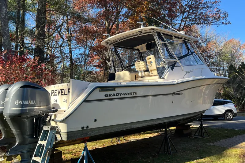 Revelry Yacht Photos Pics 2003 Grady-White Express 330 boat on stands, with Yamaha engines, surrounded by autumn trees.