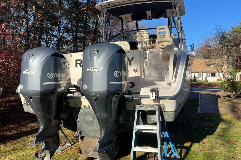 Revelry Yacht Photos Pics 2003 Grady-White Express 330 boat with twin Yamaha 250 engines, parked outdoors.