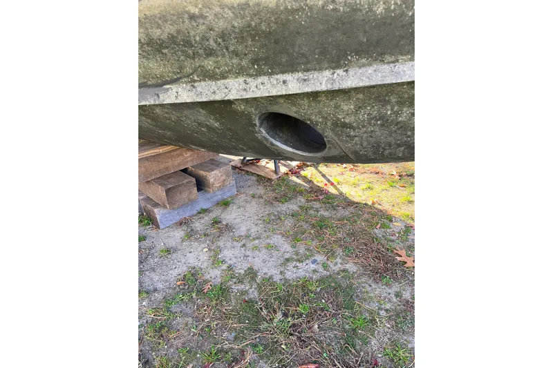 Revelry Yacht Photos Pics 2003 Grady-White Express 330 boat hull on blocks, showing drainage hole.