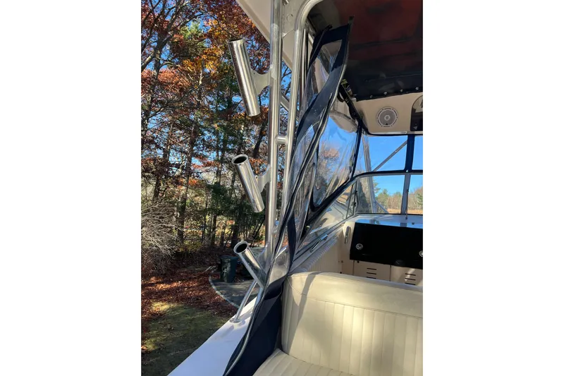 Revelry Yacht Photos Pics 2003 Grady-White Express 330 boat interior with rod holders and clear enclosure.