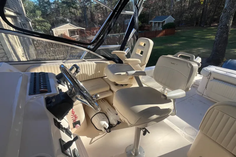 Revelry Yacht Photos Pics 2003 Grady-White Express 330 boat cockpit with steering wheel and seating.