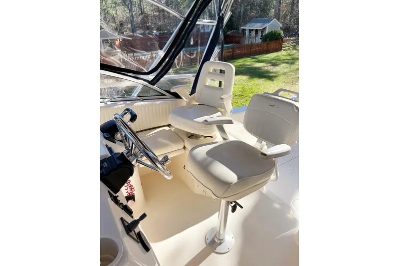Revelry Yacht Photos Pics 2003 Grady-White Express 330 boat cockpit with dual captain chairs and steering wheel.