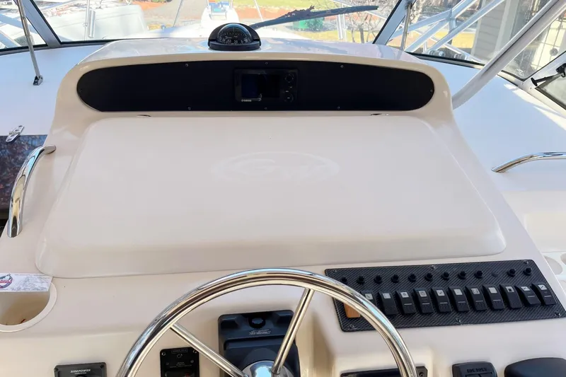 Revelry Yacht Photos Pics Helm of 2003 Grady-White Express 330 boat with steering wheel and control panel.
