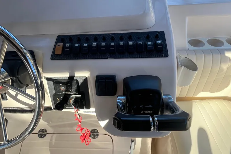 Revelry Yacht Photos Pics 2003 Grady-White Express 330 helm with Yamaha controls and switches.