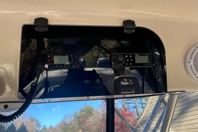 Revelry Yacht Photos Pics 2003 Grady-White Express 330 boat dashboard with radio and control panel.