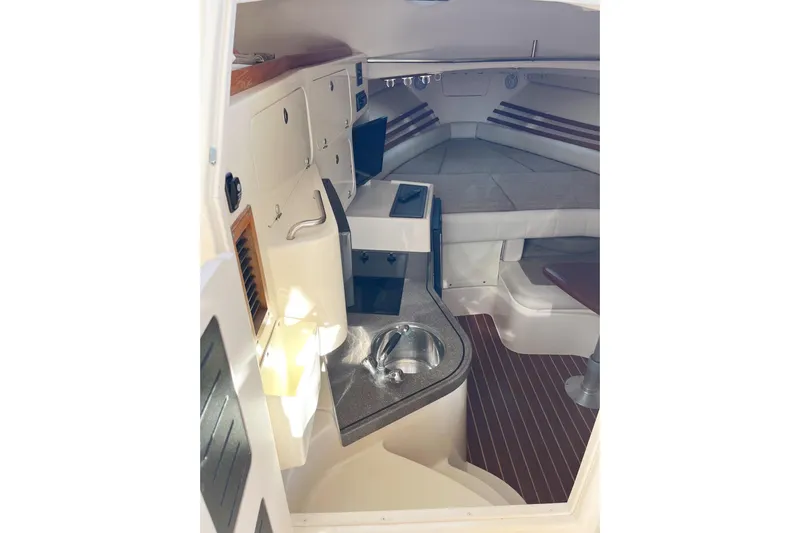 Revelry Yacht Photos Pics 2003 Grady-White Express 330 cabin interior with kitchenette and seating area.