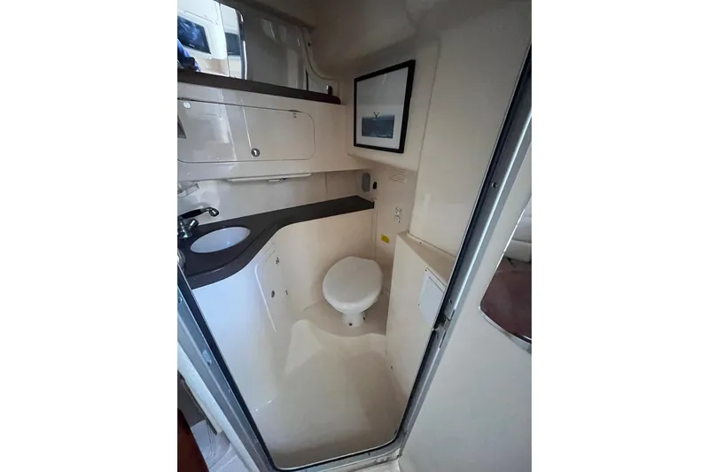 Revelry Yacht Photos Pics 2003 Grady-White Express 330 boat bathroom interior with sink and toilet.