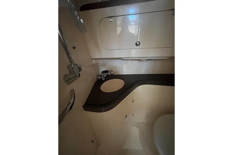 Revelry Yacht Photos Pics 2003 Grady-White Express 330 boat bathroom with sink and storage cabinet.