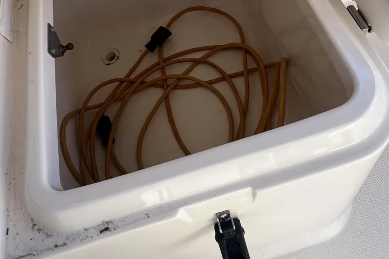 Revelry Yacht Photos Pics Storage compartment with coiled cable on 2003 Grady-White Express 330 boat.