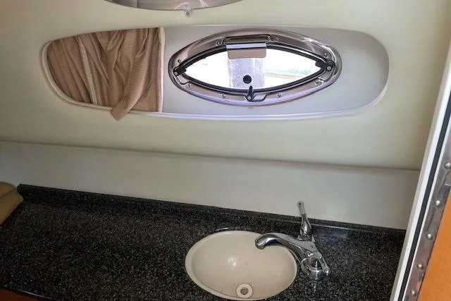 Seahorse Yacht Photos Pics 2007 Chaparral 330 Signature boat interior with sink and porthole window.