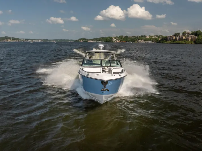  Yacht Photos Pics 2024 Monterey 385SS boat cruising on a lake under a clear blue sky.