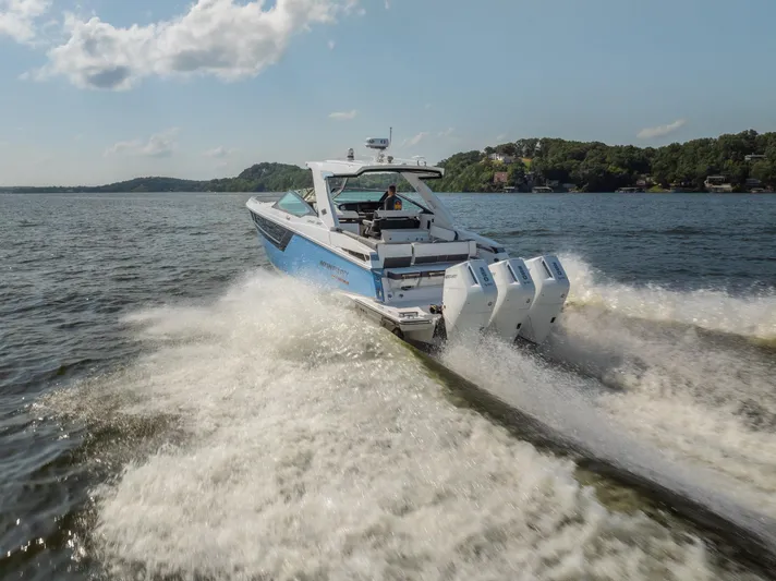  Yacht Photos Pics 2024 Monterey 385SS boat cruising on a lake with powerful engines.