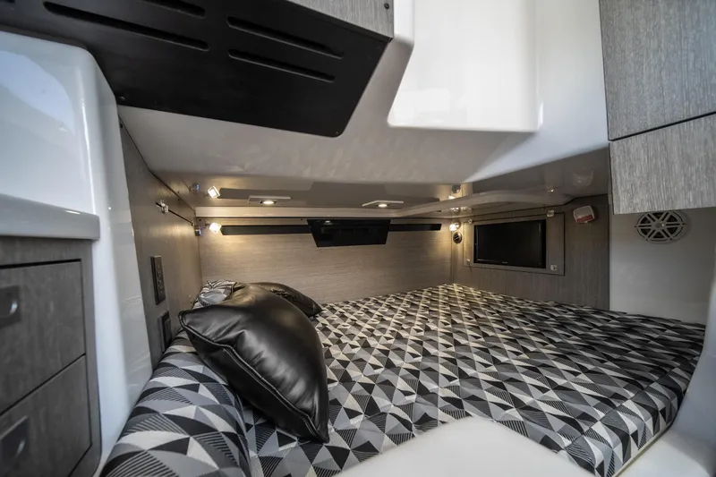  Yacht Photos Pics 2024 Monterey 385SS cabin interior with geometric-patterned bedding and modern lighting.