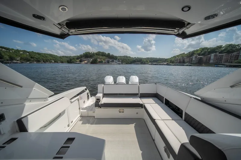  Yacht Photos Pics 2024 Monterey 385SS boat interior with spacious seating, overlooking a scenic lake view.