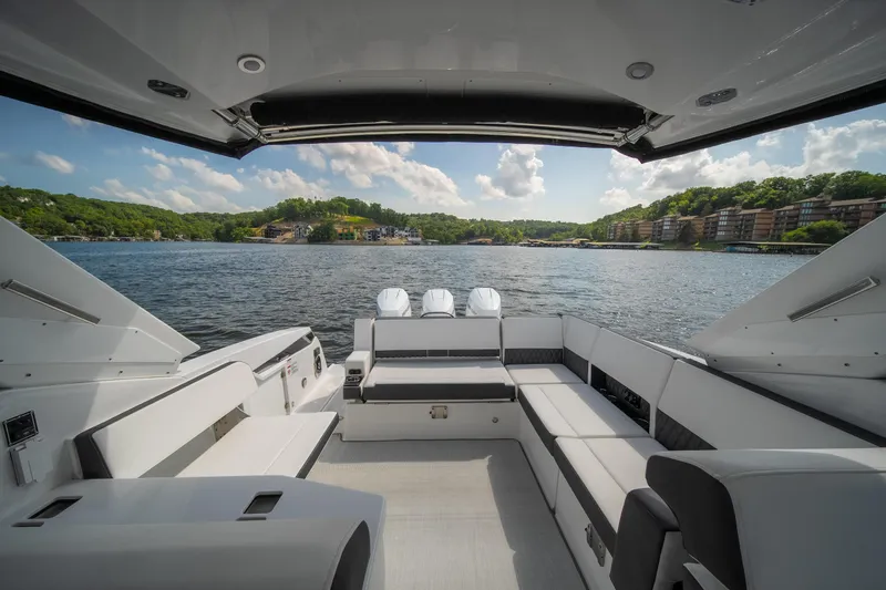  Yacht Photos Pics 2024 Monterey 385SS boat interior with lake view, featuring spacious seating and modern design.