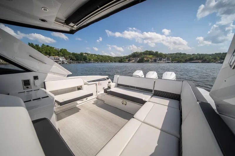  Yacht Photos Pics 2024 Monterey 385SS boat interior with spacious seating, overlooking a scenic lake view.