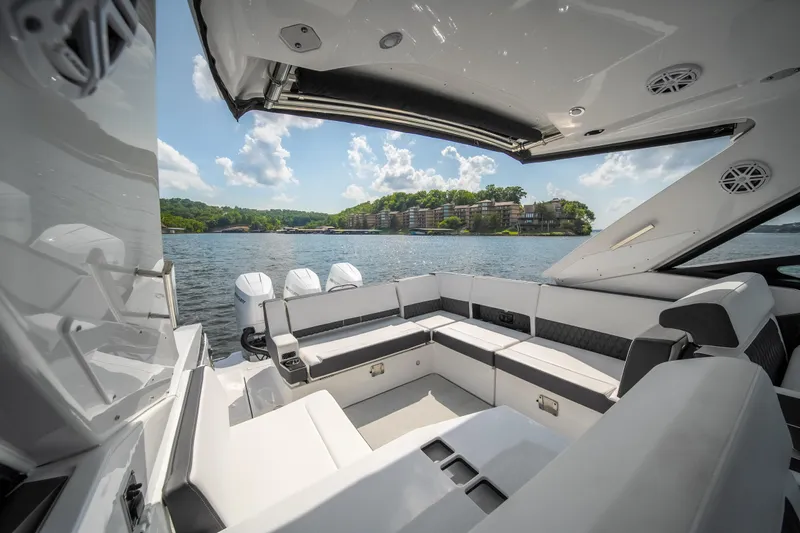  Yacht Photos Pics 2024 Monterey 385SS boat interior with luxurious seating, overlooking a scenic waterfront view.