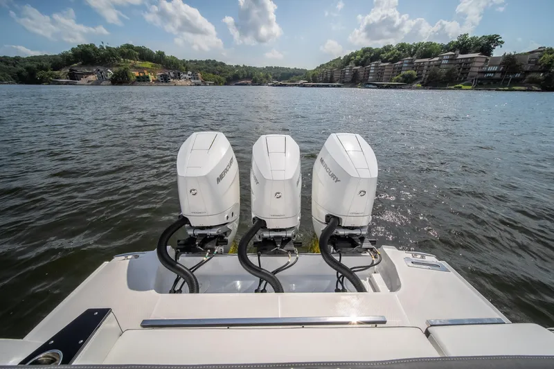  Yacht Photos Pics 2024 Monterey 385SS boat with triple Mercury outboard engines on a scenic lake.