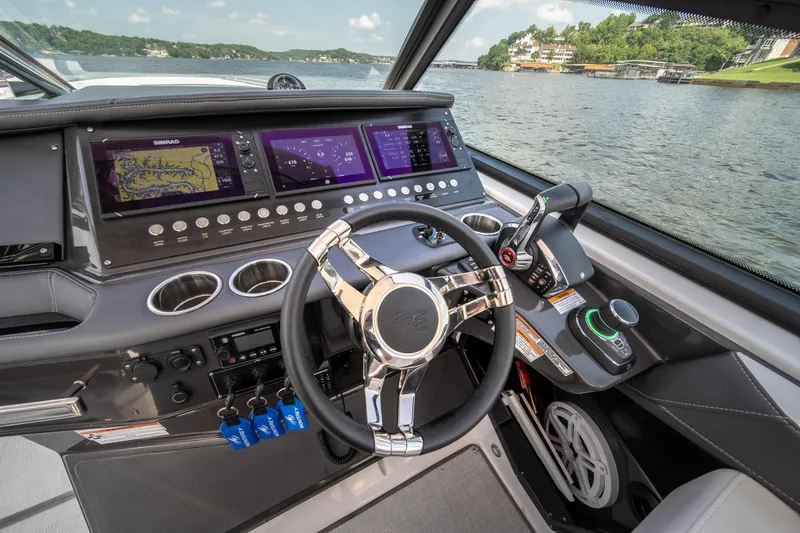  Yacht Photos Pics 2024 Monterey 385SS boat dashboard with advanced navigation and control systems on a scenic lake.