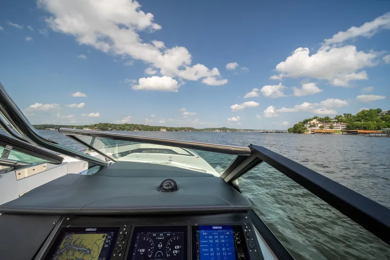 Yacht Photos Pics 2024 Monterey 385SS boat dashboard view on a sunny lake with blue skies.
