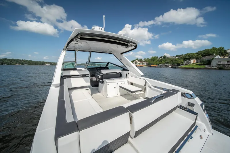  Yacht Photos Pics 2024 Monterey 385SS boat interior with spacious seating on a sunny lake.