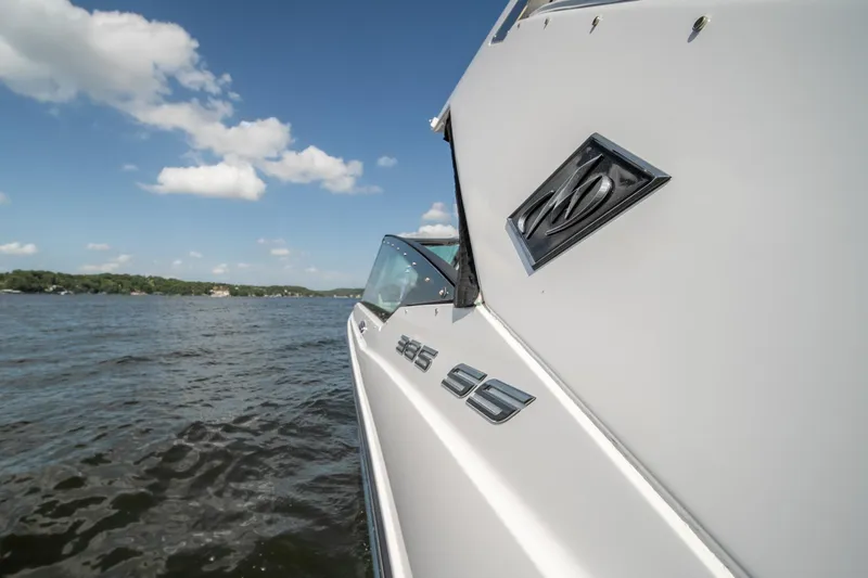  Yacht Photos Pics 2024 Monterey 385SS boat on a lake under a clear blue sky.