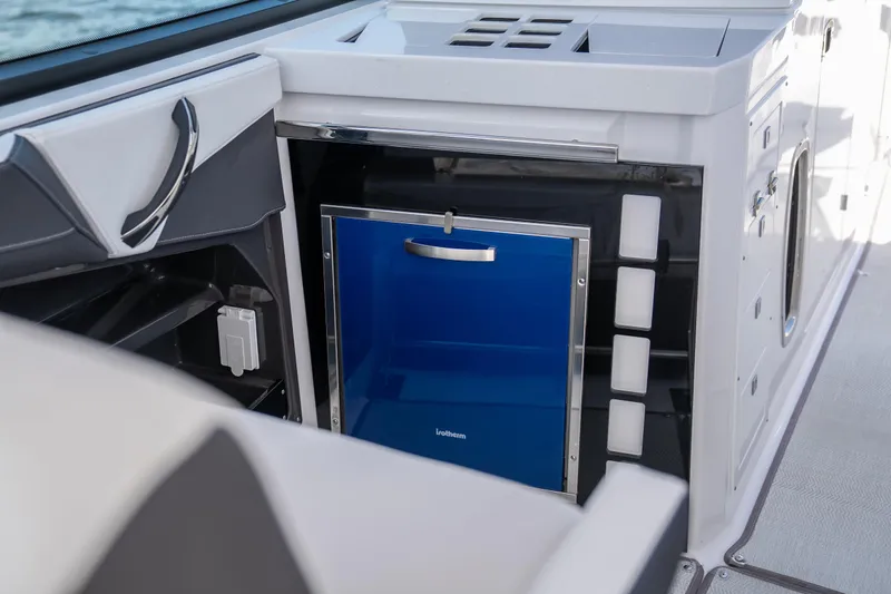  Yacht Photos Pics 2024 Monterey 385SS boat interior with a sleek blue mini-fridge.