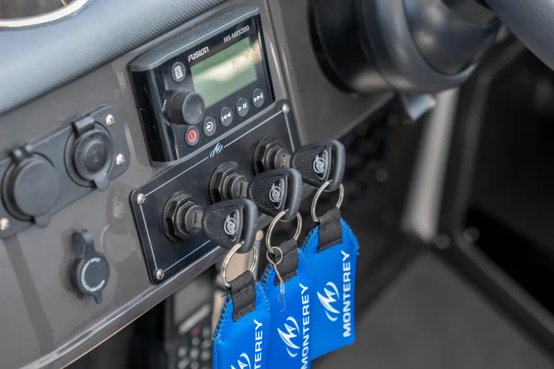  Yacht Photos Pics Control panel of 2024 Monterey 385SS boat with keys and audio system.