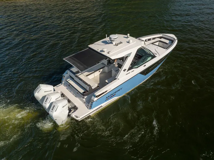  Yacht Photos Pics 2024 Monterey 385SS boat cruising on water, featuring dual Mercury outboard engines.