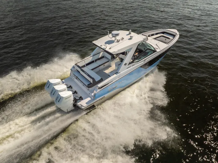  Yacht Photos Pics 2024 Monterey 385SS boat cruising on open water, showcasing powerful triple engines.