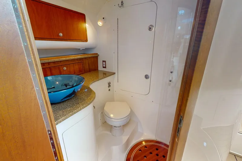  Yacht Photos Pics 2007 Midnight Express 37 Cabin bathroom with modern sink and wooden cabinetry.
