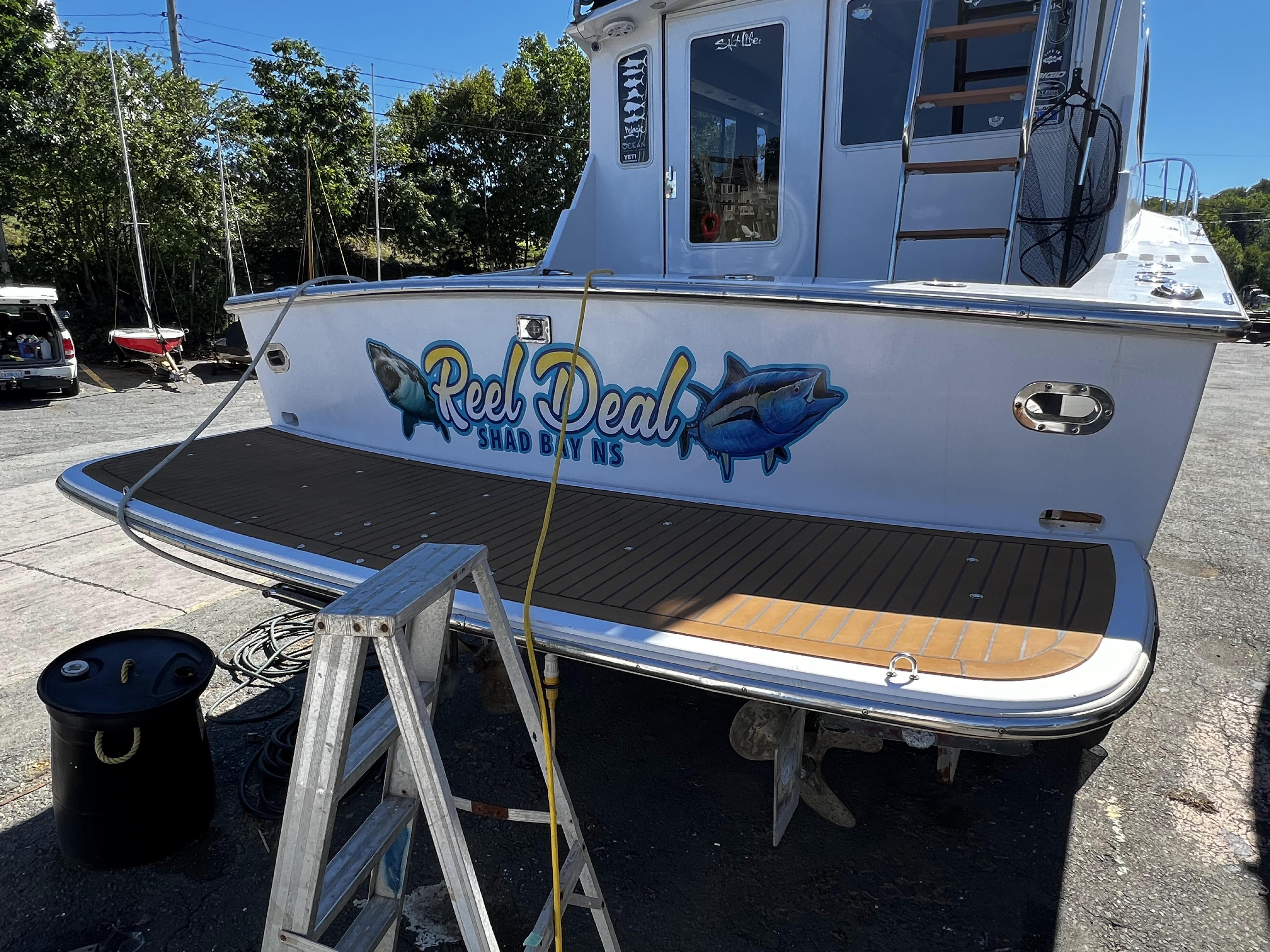 1988 Pace 40 Sport Fisherman boat with "Reel Deal" graphics on the stern.