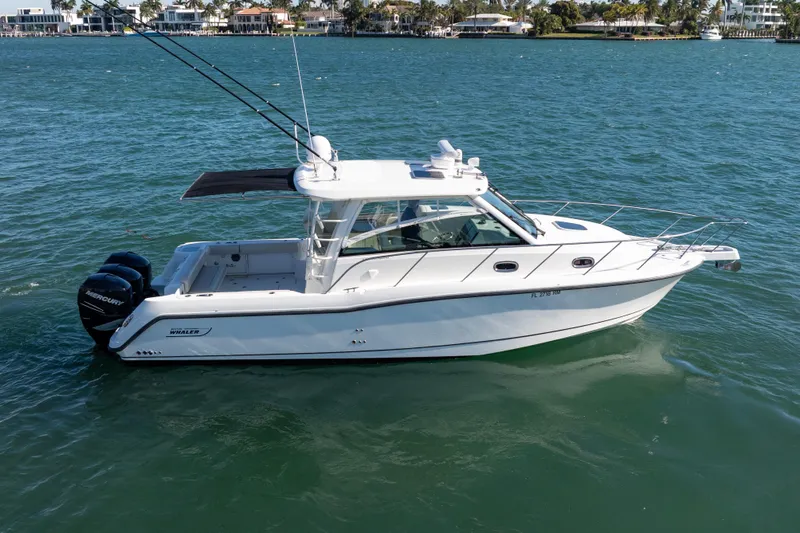  Yacht Photos Pics 2015 Boston Whaler 345 Conquest boat on water, side view, with twin Mercury engines.