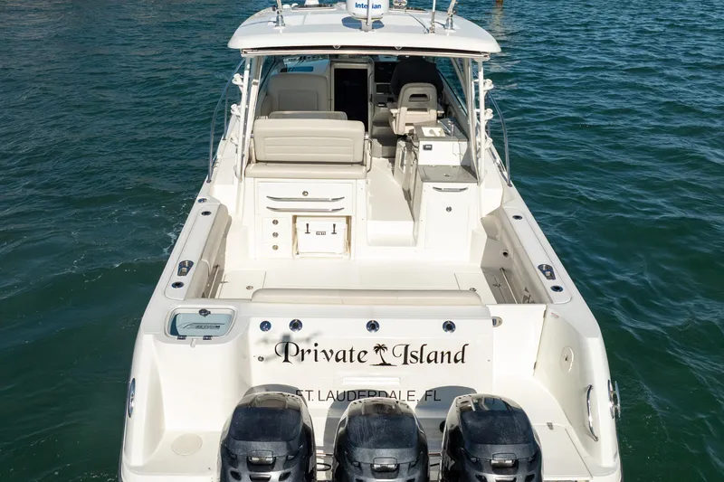  Yacht Photos Pics 2015 Boston Whaler 345 Conquest boat on water, rear view, named "Private Island."