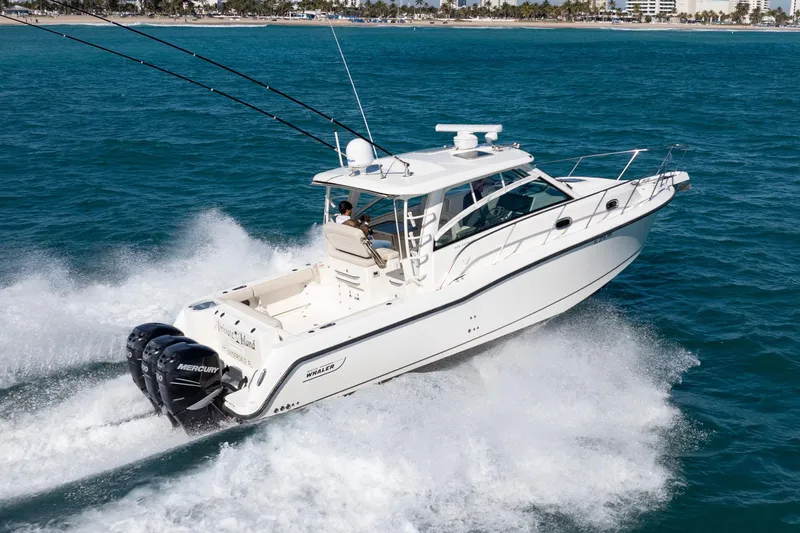  Yacht Photos Pics 2015 Boston Whaler 345 Conquest cruising on open water with twin Mercury engines.