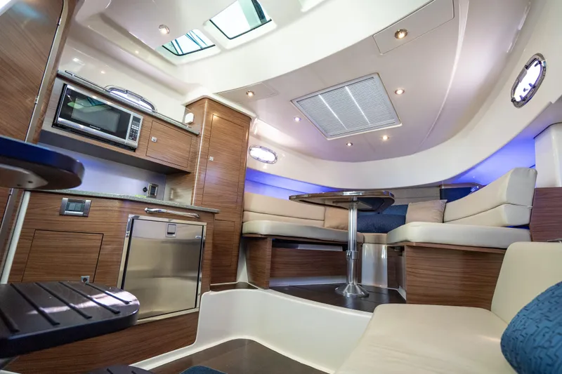  Yacht Photos Pics Luxurious interior of 2015 Boston Whaler 345 Conquest with modern kitchen and seating area.